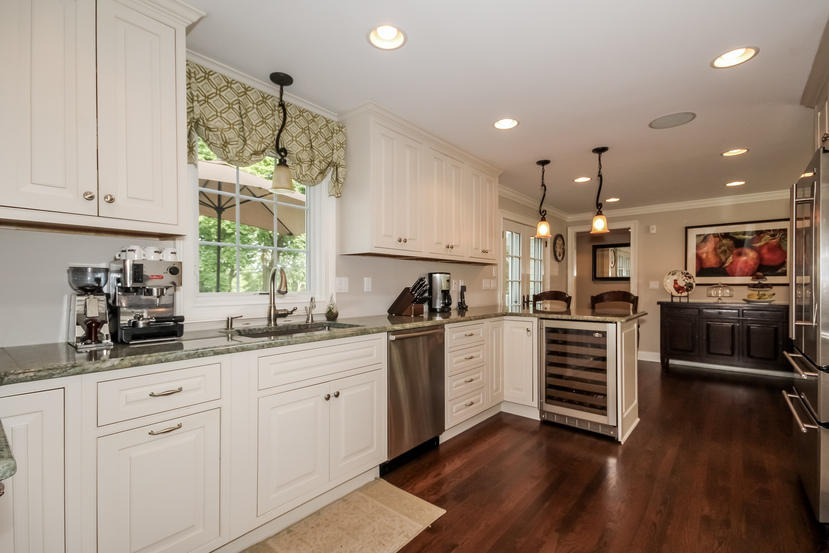 9 Field Crest Road New Canaan, CT 06840 - Photo 7 of 25 a kitchen with white cabinets and stainless steel appliances