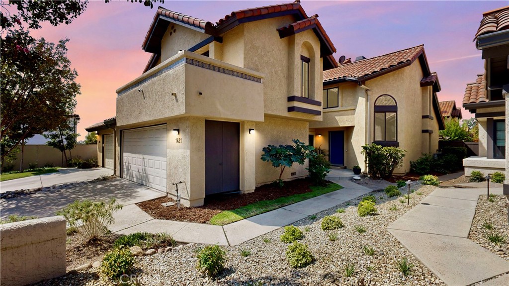 1421 Rust Court Claremont, CA 91711 - Photo 1 of 47 a view of a white house with large windows next to a road