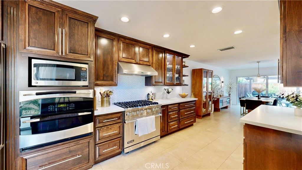 1421 Rust Court Claremont, CA 91711 - Photo 20 of 47 a kitchen with stainless steel appliances granite countertop a stove and cabinets