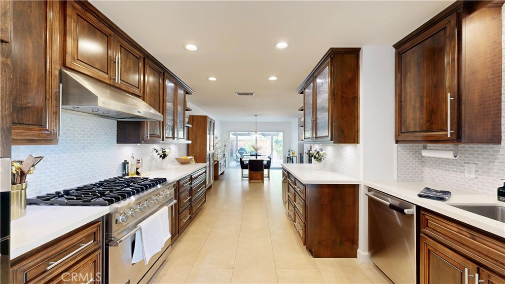 1421 Rust Court Claremont, CA 91711 - Photo 21 of 47 a large kitchen with stainless steel appliances granite countertop a stove top oven a sink dishwasher and a refrigerator