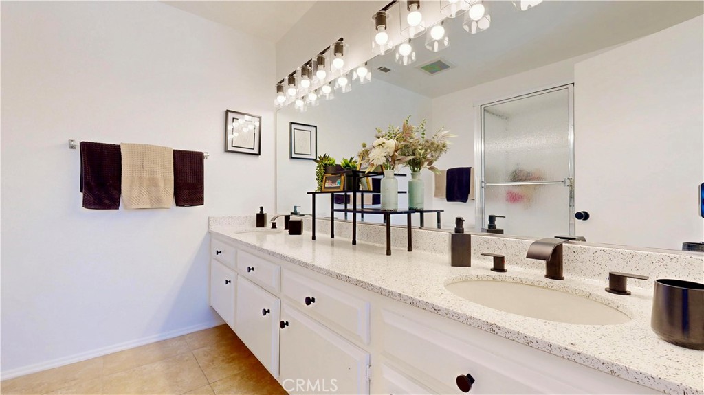1421 Rust Court Claremont, CA 91711 - Photo 38 of 47 a bathroom with a granite countertop sink a large mirror and a shower