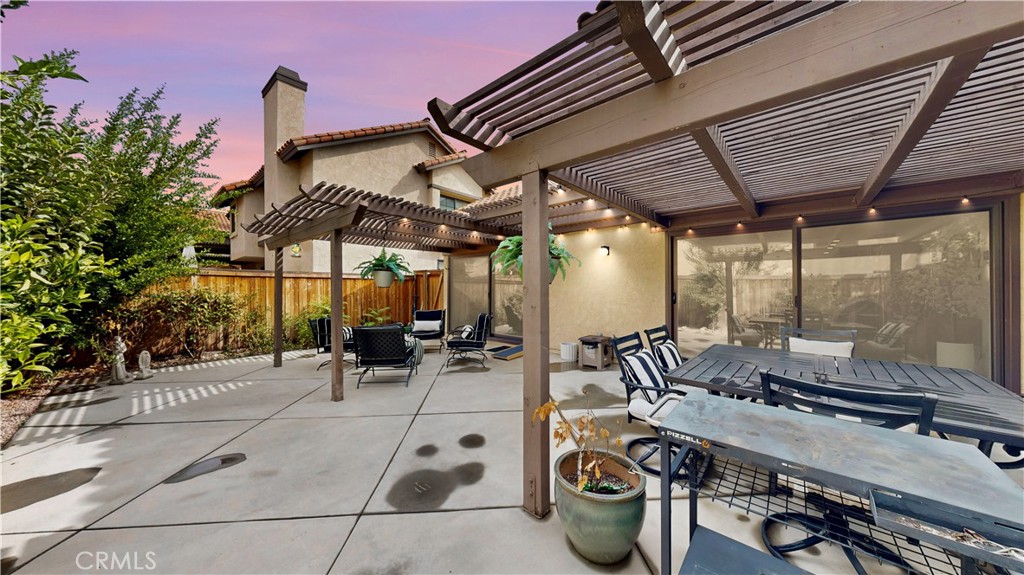 1421 Rust Court Claremont, CA 91711 - Photo 40 of 47 a view of a patio with table and chairs potted plants and large tree