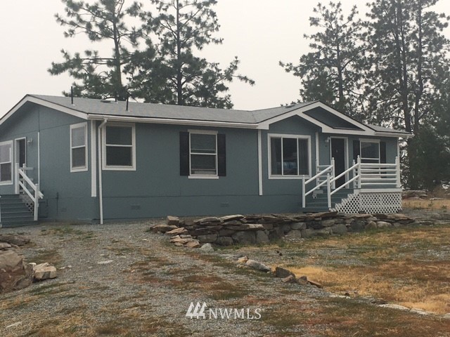 94 Main Road Tonasket, WA 98855 - Photo 1 of 25 a view of a house with a yard