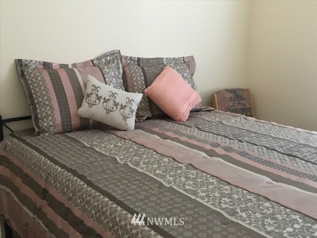 94 Main Road Tonasket, WA 98855 - Photo 13 of 25 a large bed sitting in a bedroom next to a couch