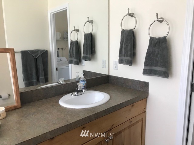 94 Main Road Tonasket, WA 98855 - Photo 14 of 25 a bathroom with a sink vanity and mirror