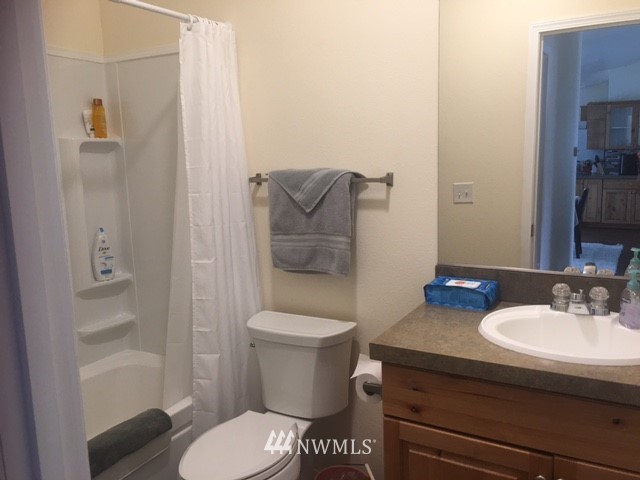 94 Main Road Tonasket, WA 98855 - Photo 16 of 25 a bathroom with a sink toilet and shower