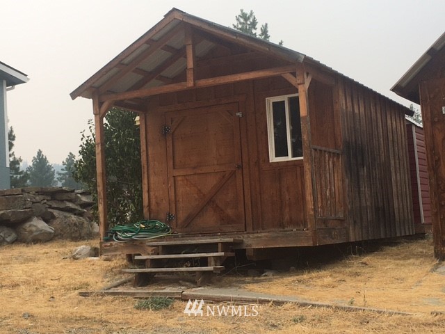 94 Main Road Tonasket, WA 98855 - Photo 18 of 25 a view of a house with a wooden fence
