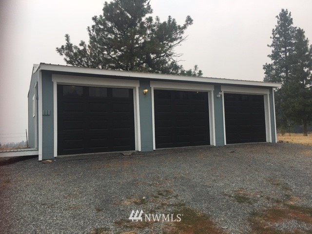 94 Main Road Tonasket, WA 98855 - Photo 23 of 25 a view of a house with a space and garage
