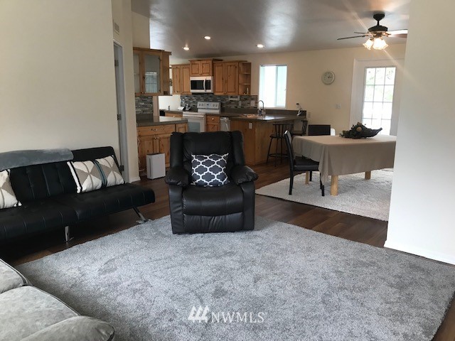 94 Main Road Tonasket, WA 98855 - Photo 5 of 25 a living room with furniture and a flat screen tv