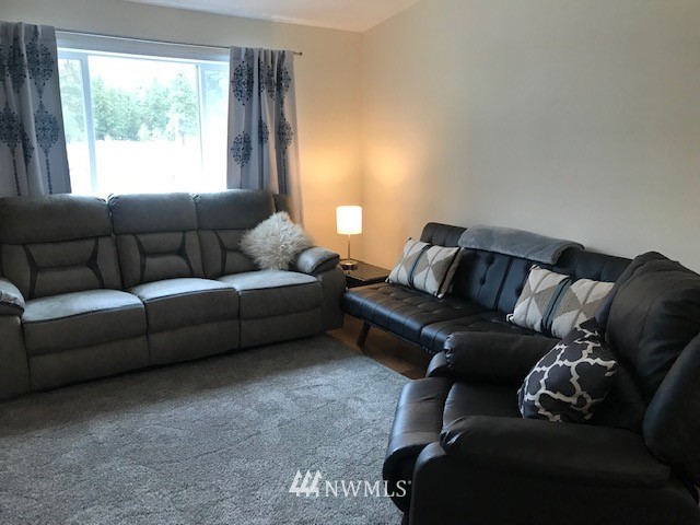 94 Main Road Tonasket, WA 98855 - Photo 6 of 25 a living room with a couch and a large window