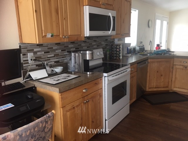 94 Main Road Tonasket, WA 98855 - Photo 7 of 25 a kitchen with a stove and a microwave