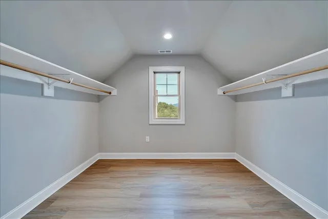 an empty room with windows and closet