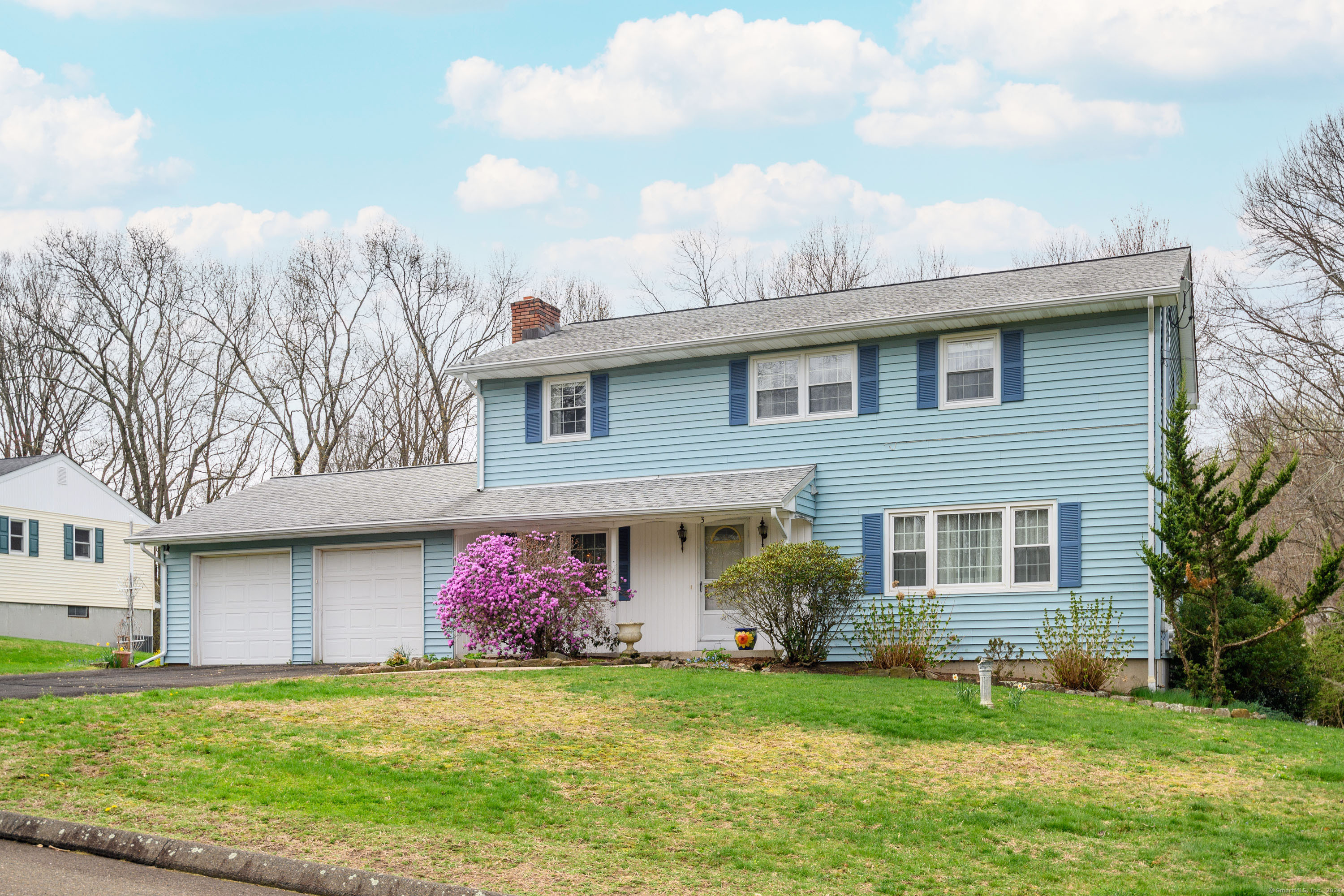 a front view of a house with a garden