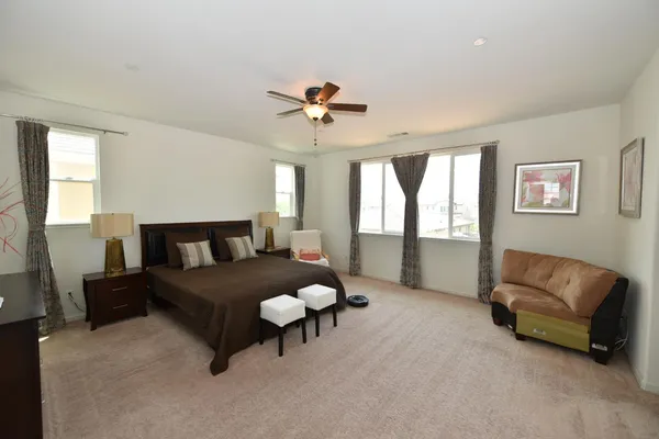 a bed room with a bed window and a chandelier