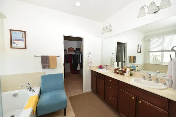 a spacious bathroom with a double vanity sink and a mirror