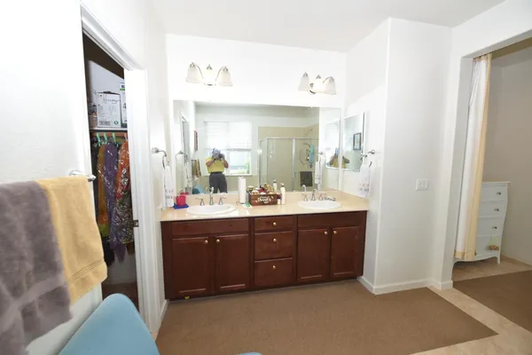 a bathroom with a tub sink shower and mirror
