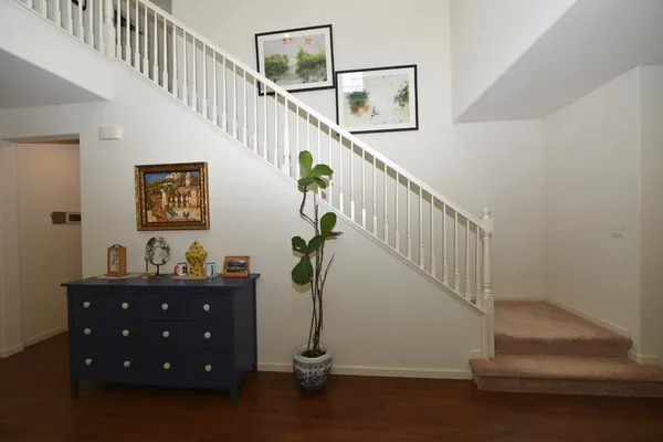 a living room with furniture a flat screen tv and a large window