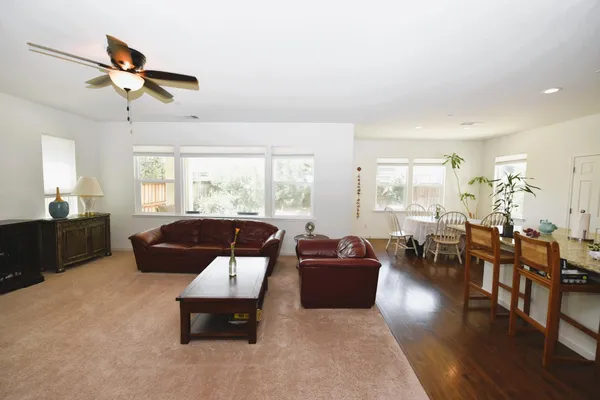 a dining room with furniture and wooden floor