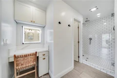 a bathroom with a double vanity sink mirror and shower