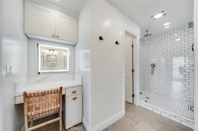 a bathroom with a double vanity sink mirror and shower