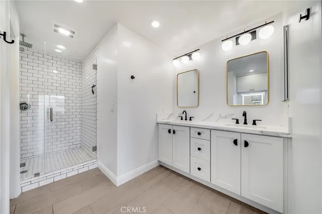 a living room with furniture kitchen view and a wooden floor