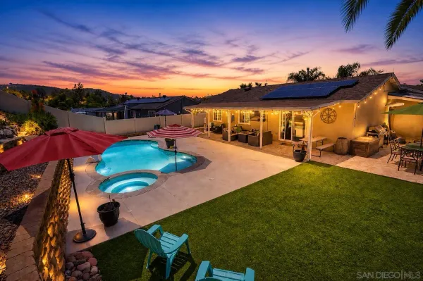 a view of a backyard with seating area