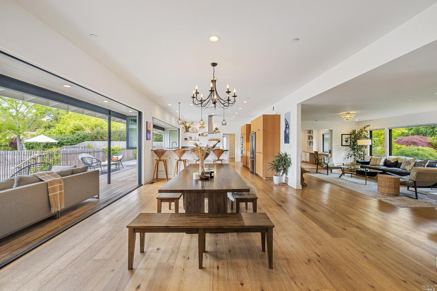 a living room with furniture large window and wooden floor