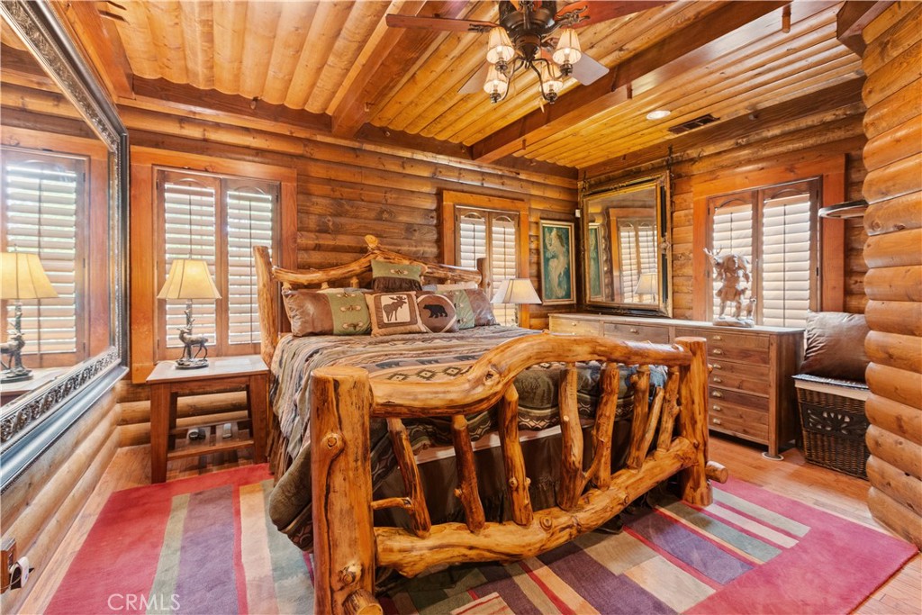 1870 Oak Springs Valley Road Wrightwood, CA 92397 - Photo 14 of 37 a spacious bedroom with a bed and a large window