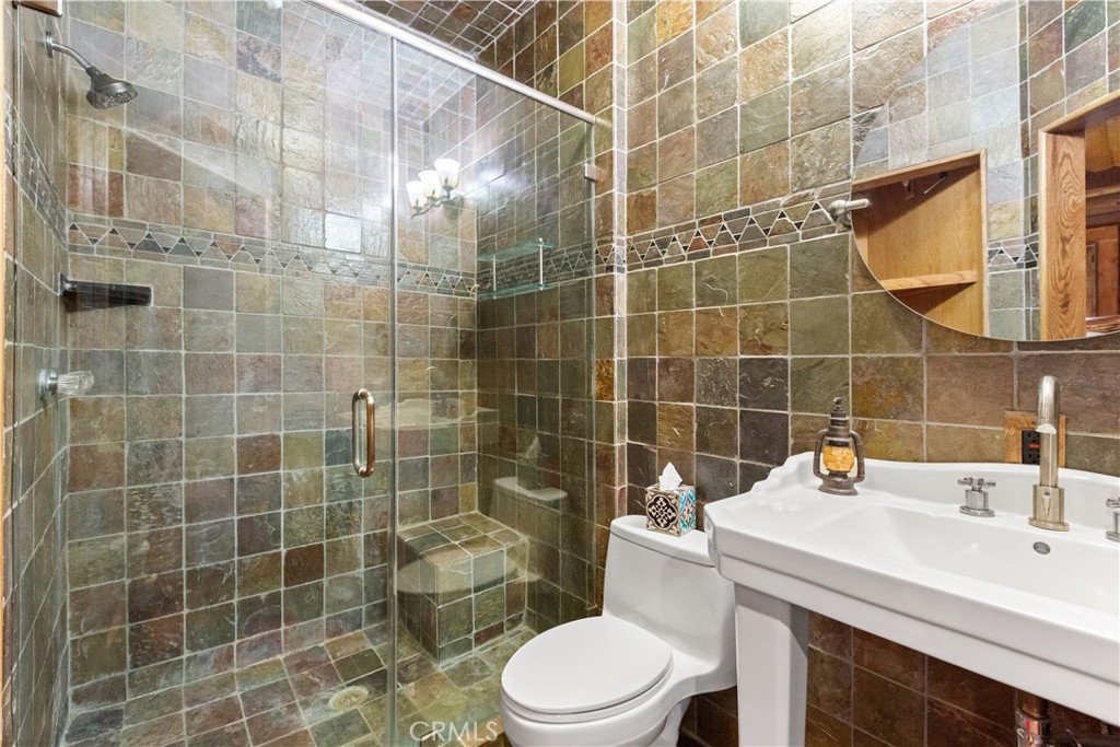 1870 Oak Springs Valley Road Wrightwood, CA 92397 - Photo 16 of 37 a bathroom with a sink a toilet and shower