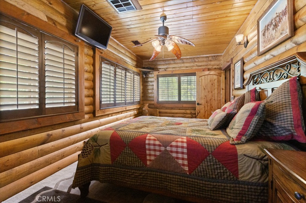 1870 Oak Springs Valley Road Wrightwood, CA 92397 - Photo 18 of 37 a bed sitting in a bedroom next to a window