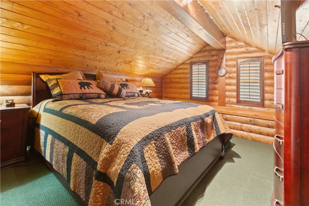 1870 Oak Springs Valley Road Wrightwood, CA 92397 - Photo 22 of 37 a bed sitting in a bedroom next to a window