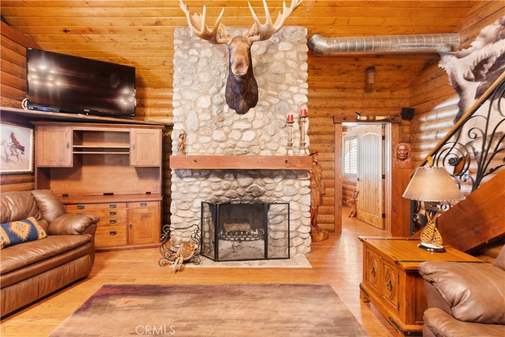 1870 Oak Springs Valley Road Wrightwood, CA 92397 - Photo 24 of 37 a living room with fireplace furniture and a flat screen tv