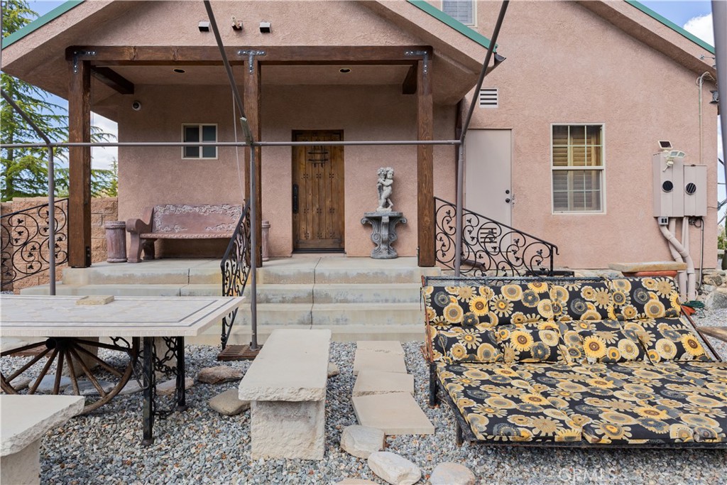 1870 Oak Springs Valley Road Wrightwood, CA 92397 - Photo 31 of 37 a view of a patio with table and chairs with wooden floor and plants