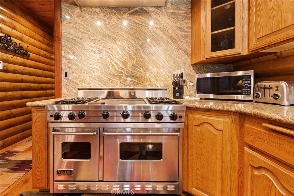 1870 Oak Springs Valley Road Wrightwood, CA 92397 - Photo 9 of 37 a stove top oven sitting inside of a kitchen