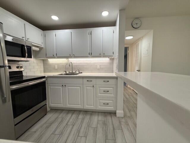 168 Northampton I West Palm Beach, FL 33417 - Photo 1 of 22 a kitchen with granite countertop a sink stove and cabinets