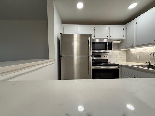 168 Northampton I West Palm Beach, FL 33417 - Photo 11 of 22 a kitchen with stainless steel appliances a refrigerator and a stove top oven