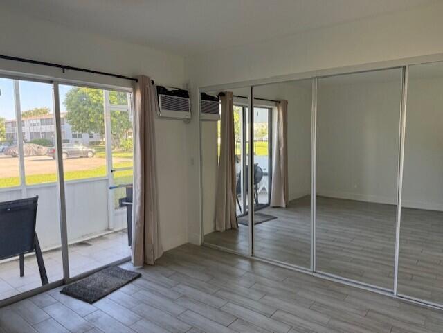 168 Northampton I West Palm Beach, FL 33417 - Photo 12 of 22 a view of empty room with wooden floor and fan