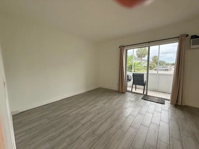 a view of an empty room with glass door