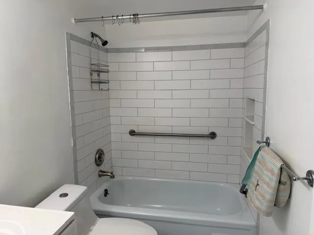 a bathroom with a bathtub and shower