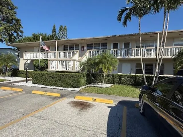 a view of a house with swimming pool and sitting area