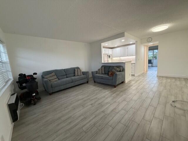 168 Northampton I West Palm Beach, FL 33417 - Photo 6 of 22 a living room with furniture and a wooden floor