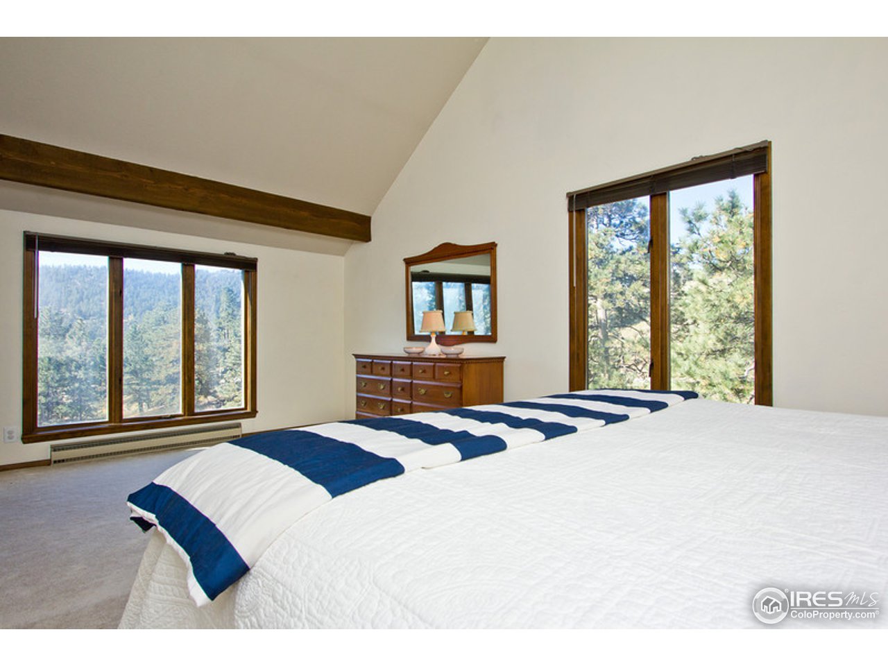 398 Broken Fence Road Boulder, CO 80302 - Photo 20 of 25 a bedroom with a bed and a large window