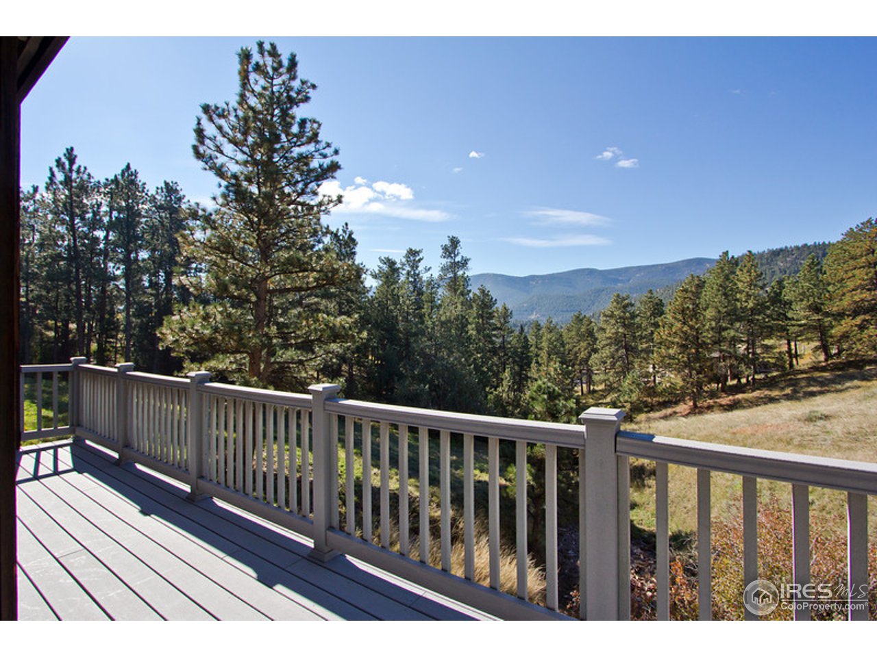 398 Broken Fence Road Boulder, CO 80302 - Photo 2 of 25 a balcony with wooden floor and fence