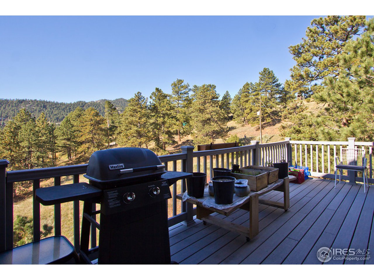 398 Broken Fence Road Boulder, CO 80302 - Photo 22 of 25 a view of a balcony with chair and wooden floor