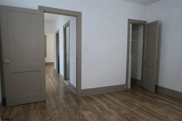 a view of a hallway with wooden floor
