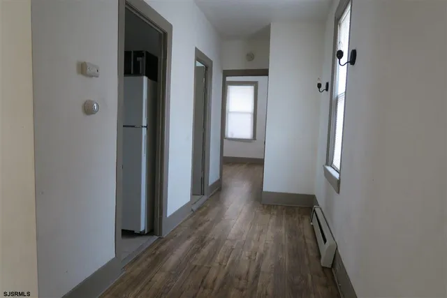 a view of hallway with wooden floor