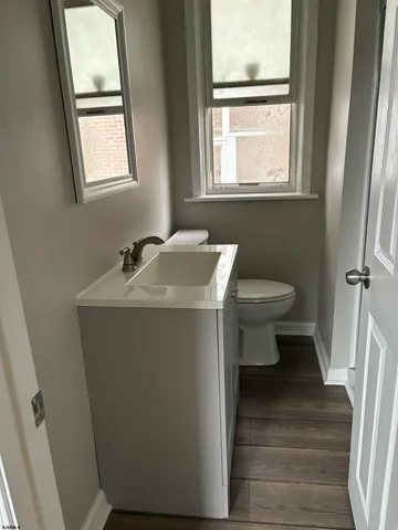 a bathroom with a sink toilet and a window