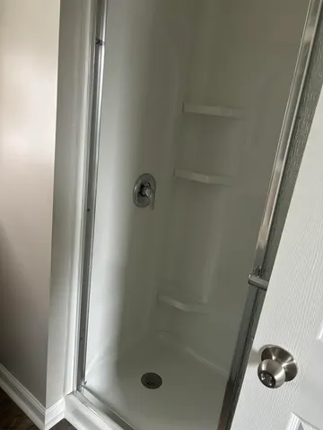 a bathroom with a glass shower door