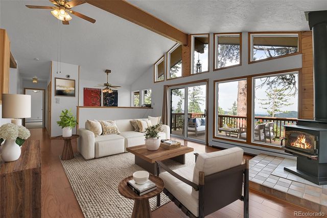 a living room with furniture and a floor to ceiling window