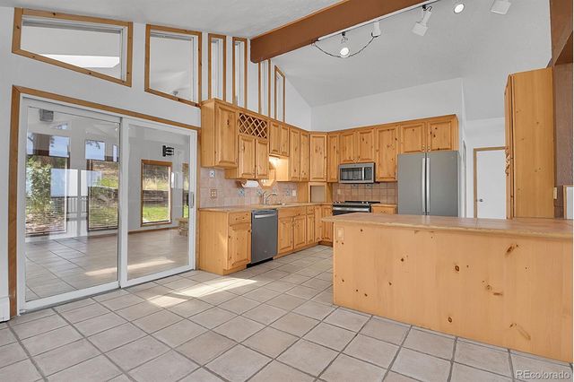 a kitchen with a sink cabinets and appliances